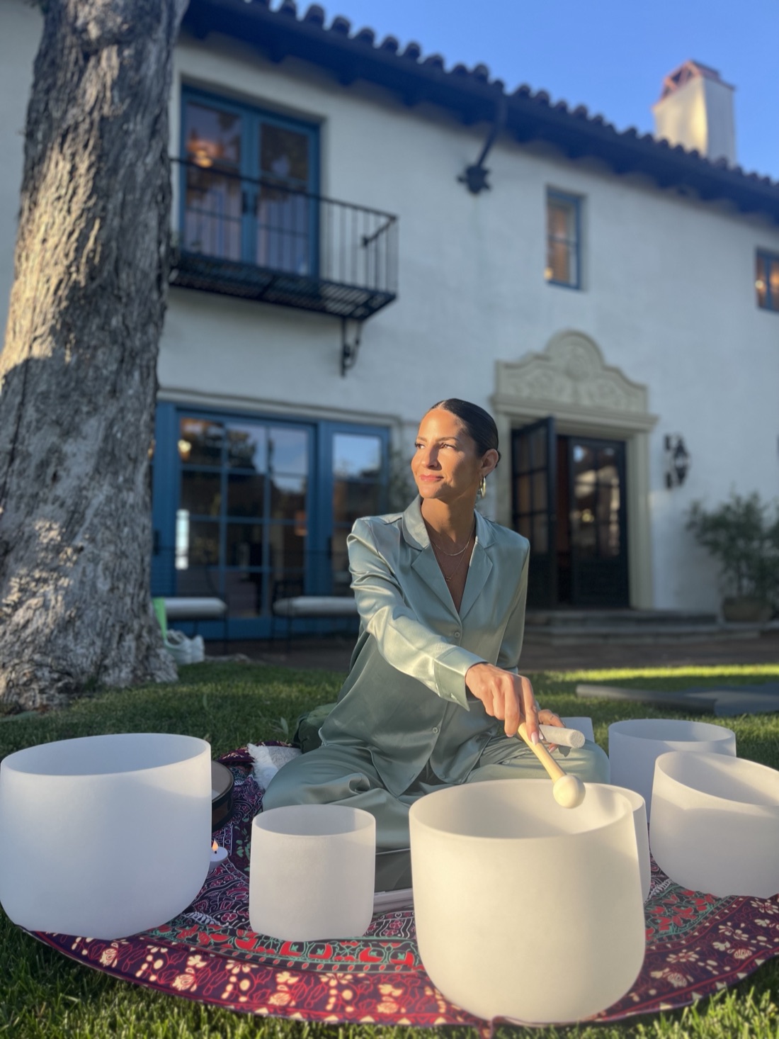 Melissa Rose playing crystal sound bowls at golden hour